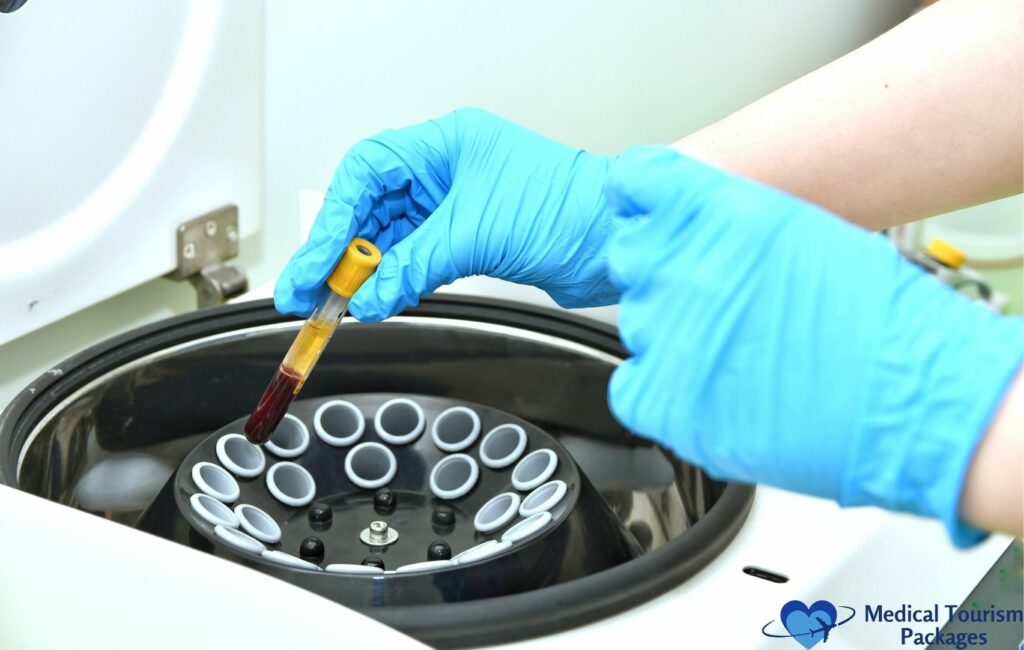 In a laboratory setting, often associated with the booming medical tourism industry in Latin America, a gloved hand carefully places a test tube with blood into the centrifuge.