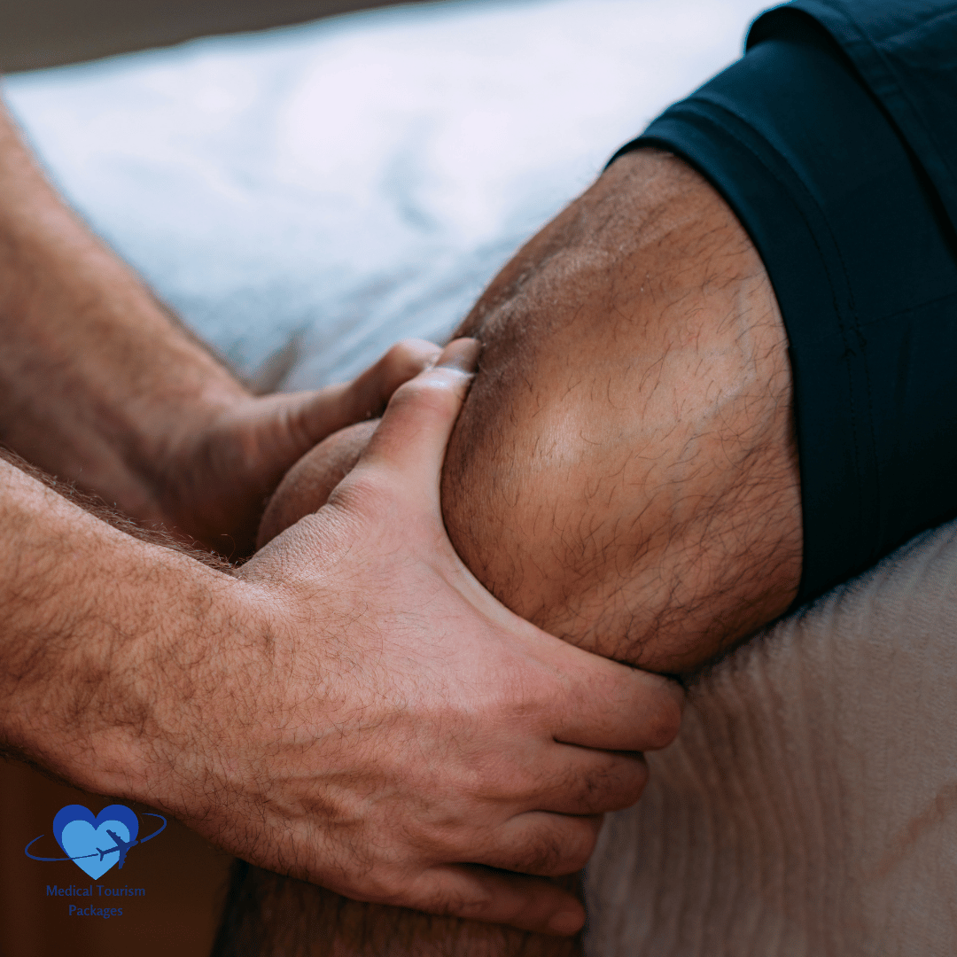 A person gets a knee massage, emphasizing the hands and knee, with a logo in the bottom left corner. This soothing technique, rooted in sports medicine, aids recovery and helps you get back in the game.